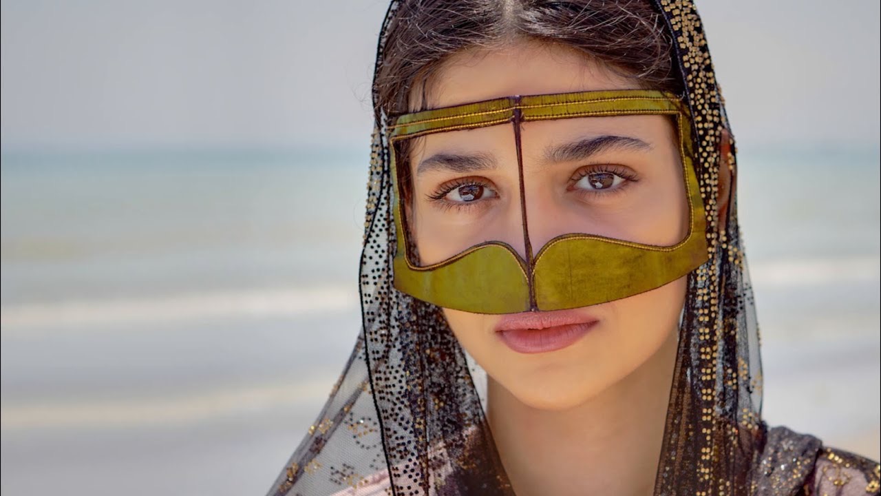 Why do some Woman wear a metallic-looking mask (batoola) in Qatar